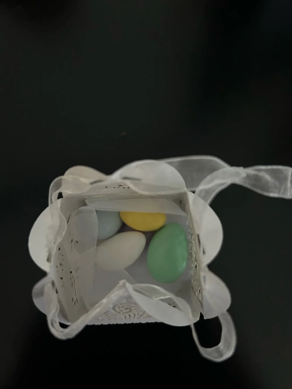 White Laser-Cut Favor Box with Ribbon filled with Jordan almonds.